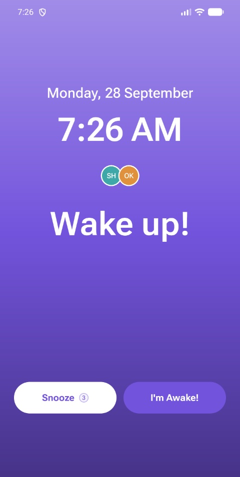 A shared alarm ringing in Blink Alarm, showing who else it woke and buttons to snooze or confirm you are awake